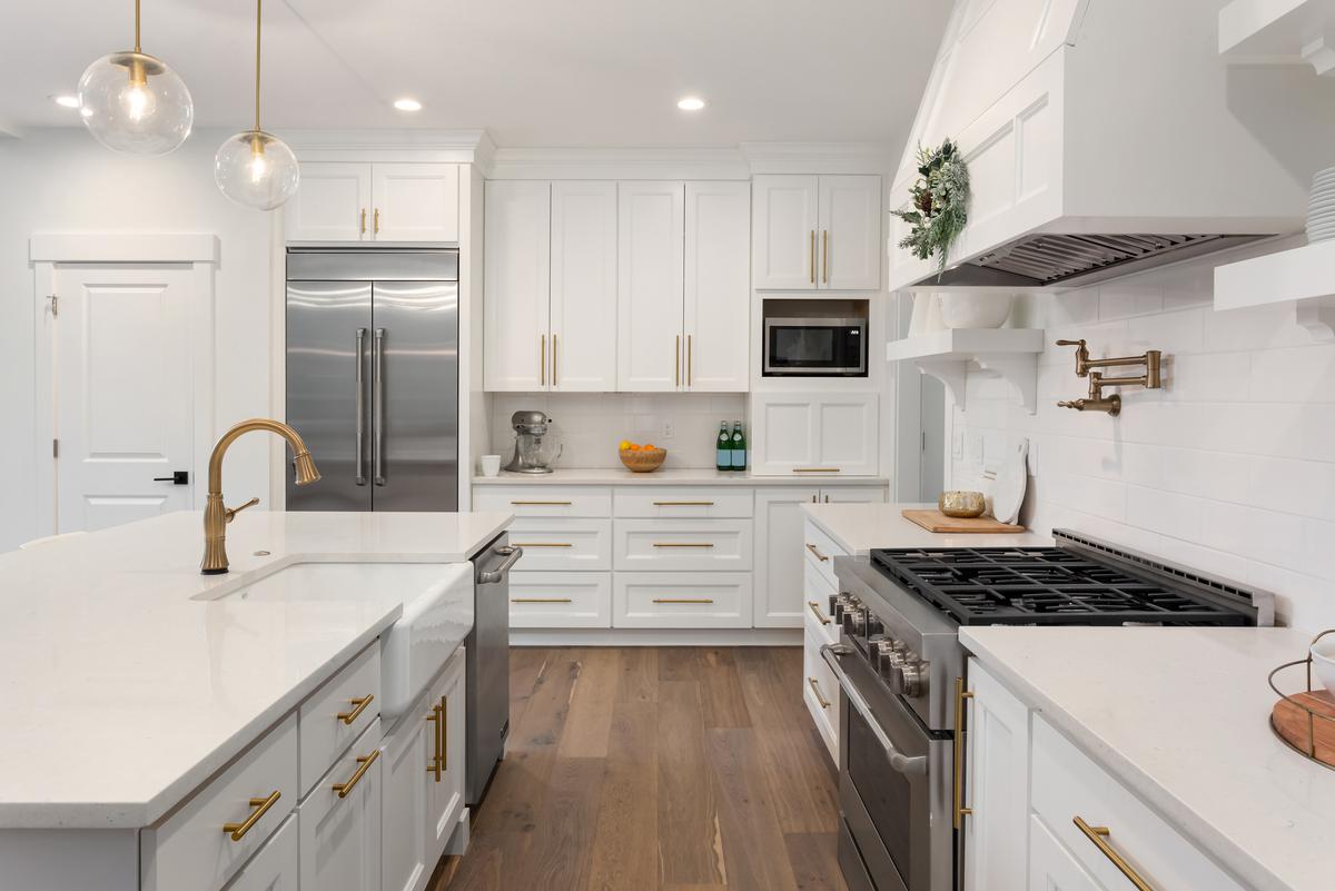 A Beautiful White Kitchen With Essential Appliances