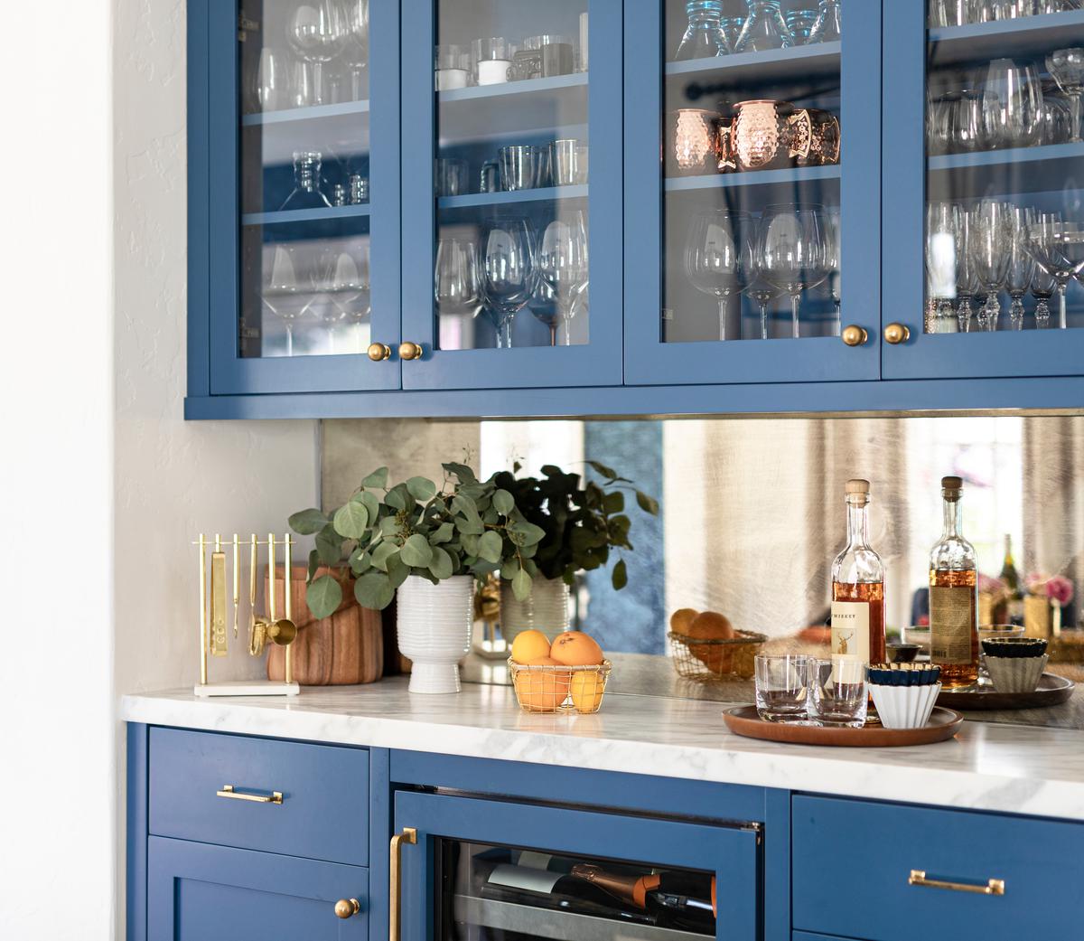 Add depth to a small kitchen with glass-paneled cabinets.