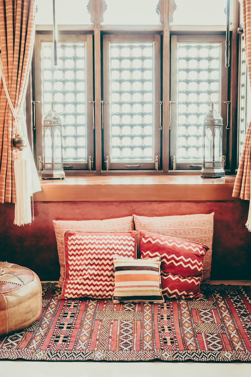 Create a Moroccan-style setting by stacking an abundance of cushions on a Berber rug.
