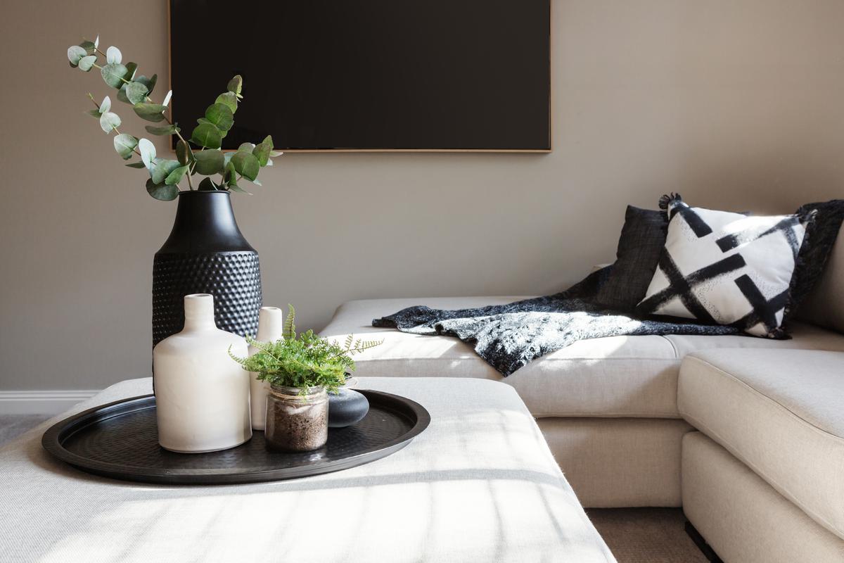 An interior decorator is principally concerned with filling the space conceived by an interior designer with character and color.