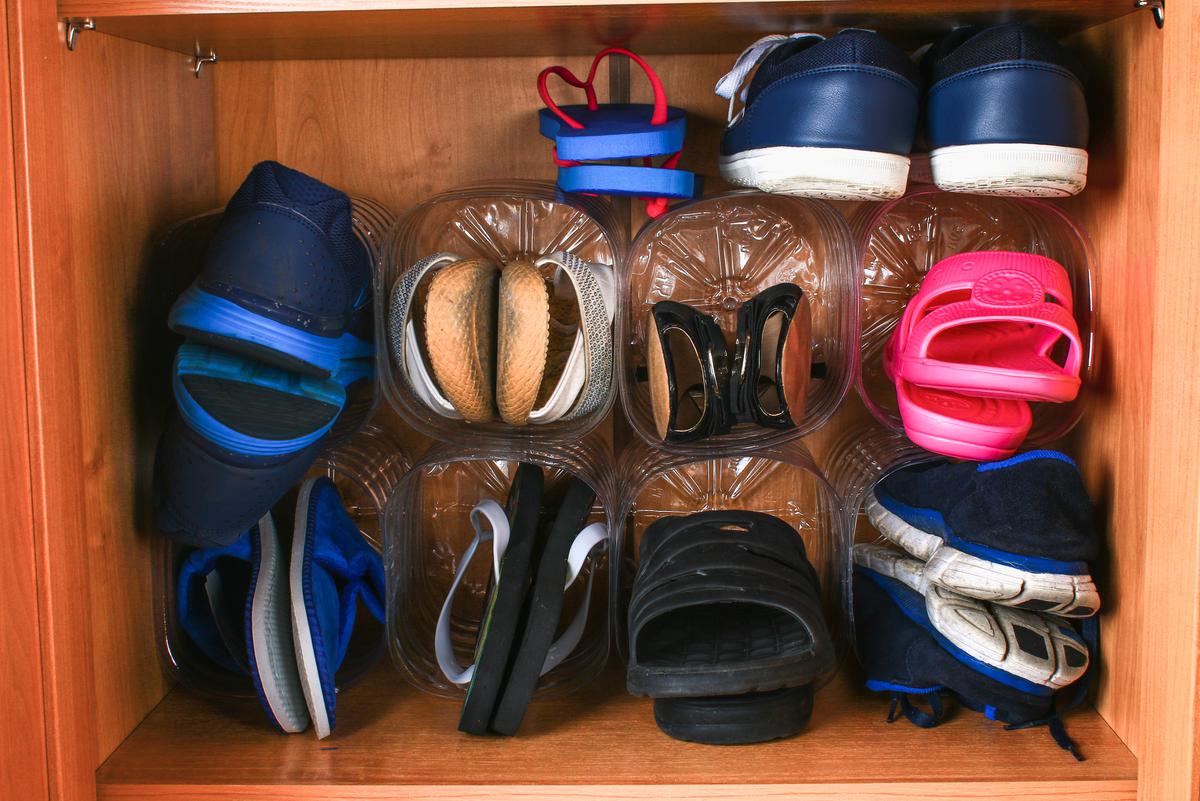 Repurposed water gallons can maximize shoe storage space in your foyer.