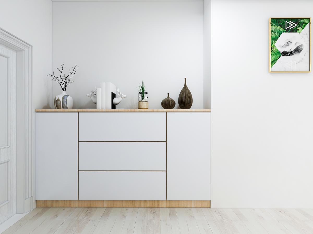 A foyer table integrated into a recess can serve form and function while saving space.