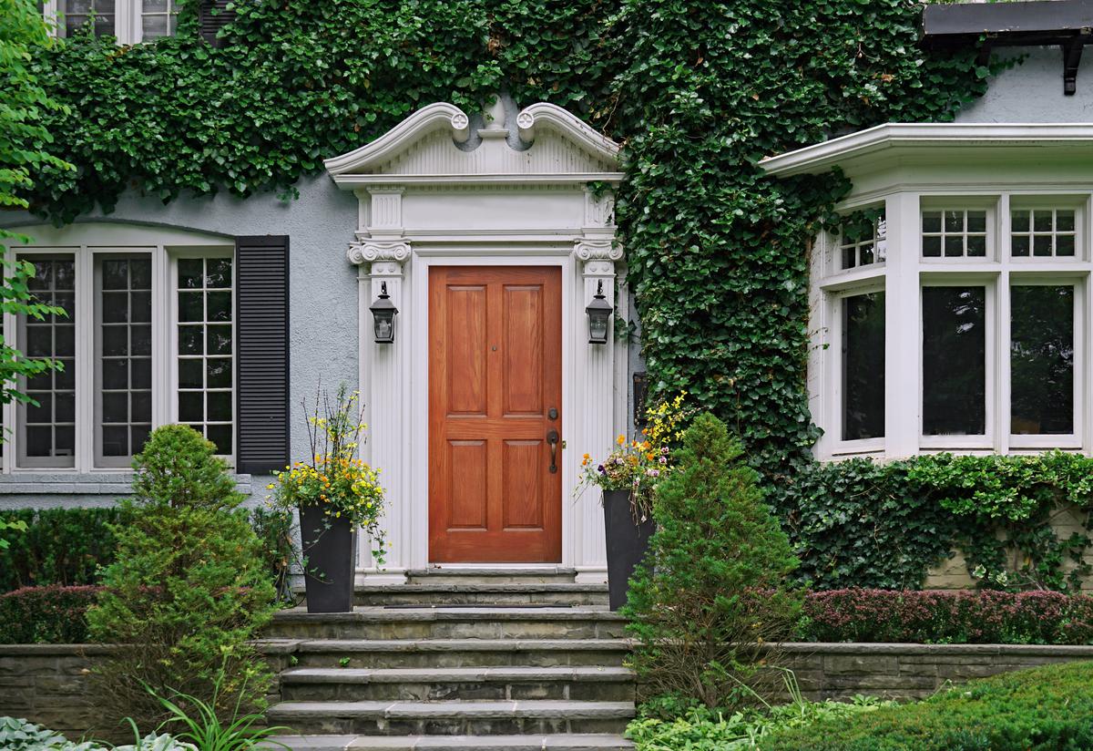 Growing vines on your exterior walls shields your home from the harsh summer heat.