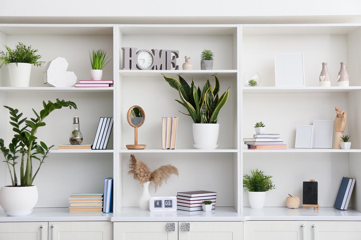 Painting DIY built-in bookshelves using the same color scheme of the room helps to integrate them better.