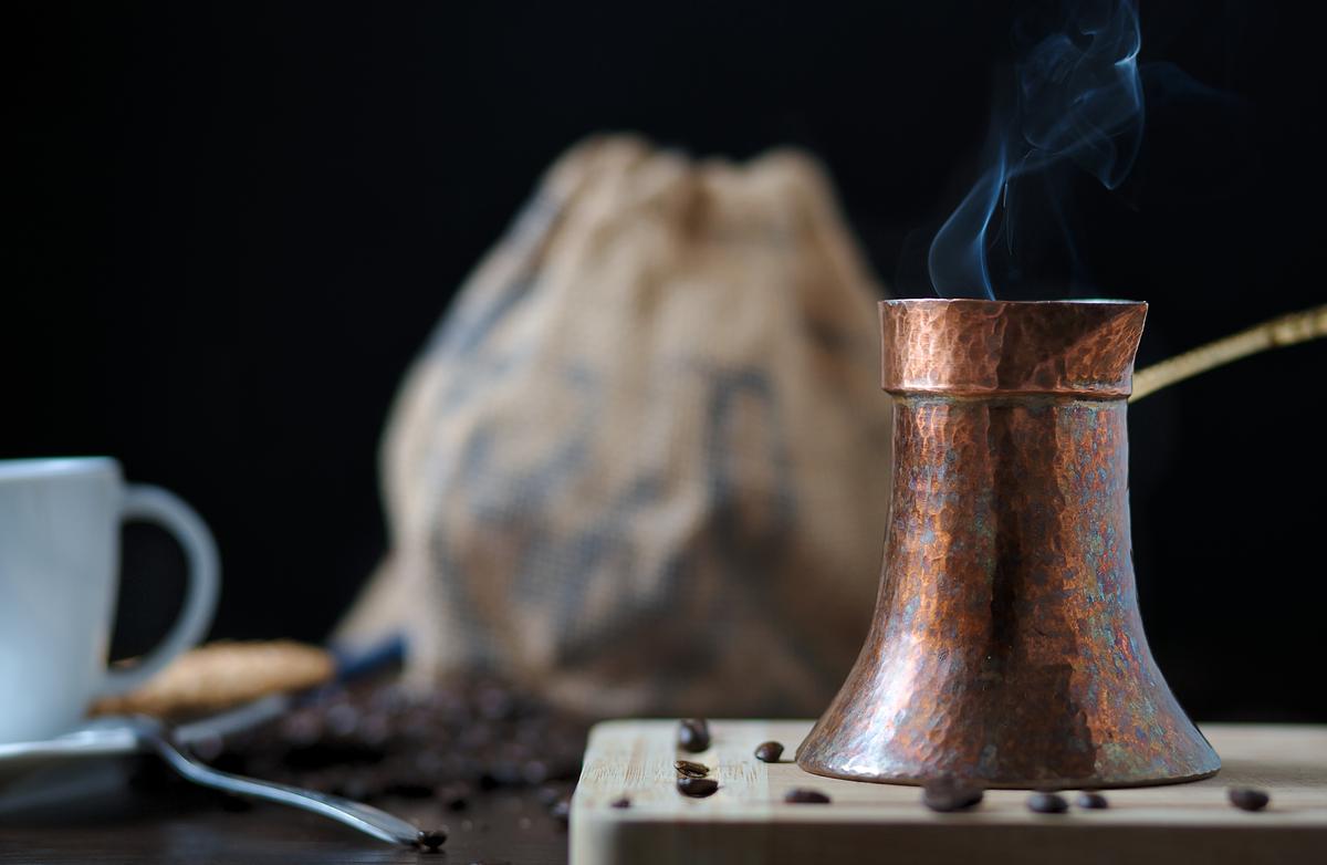 Look for materials with earthy hues such as wood and brass.