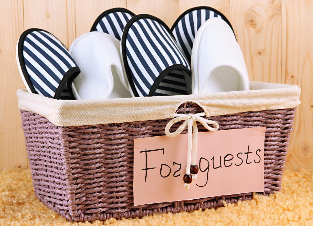 Passively let your guests know that your home is a no-shoe zone by placing slipper baskets in the entryway.