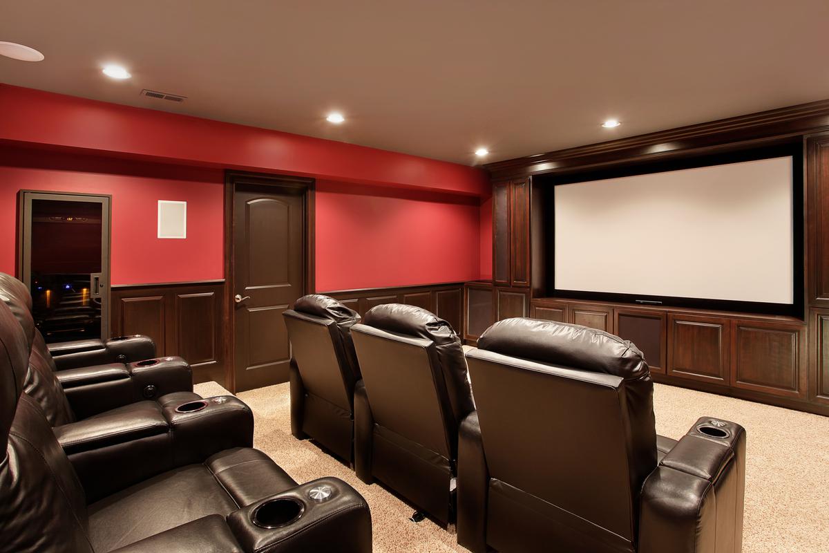 What could be more luxuriant than high-grade wood paneling, leather seating, cupholders, and a golden age-style projector screen?