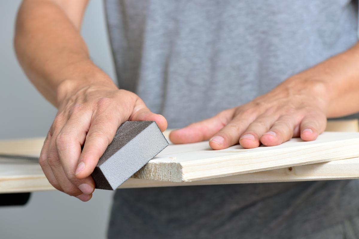 Sanding helps to remove rough edges and prepare the planks for treatment and painting.