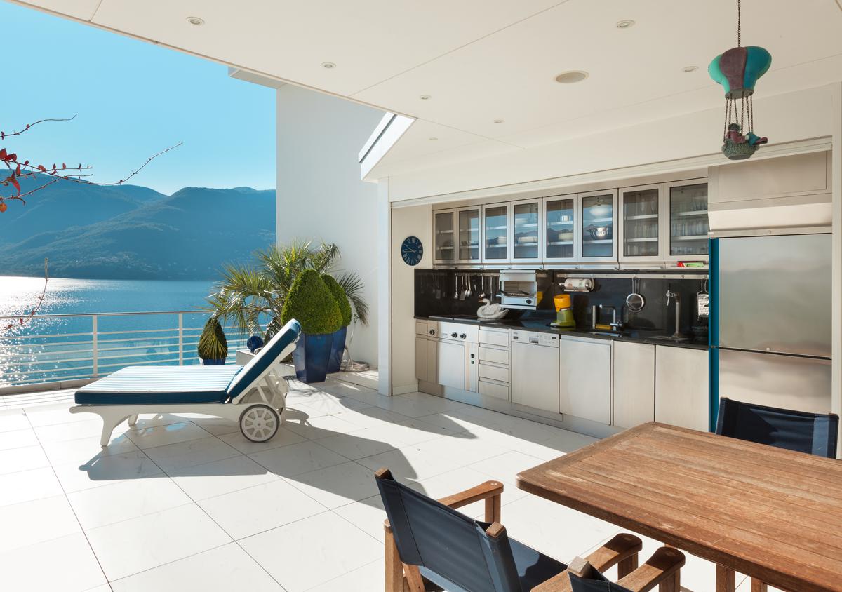 In your thoughtfully designed outdoor kitchen, every element from the sleek countertops to the ambient lighting blends functionality with aesthetics.