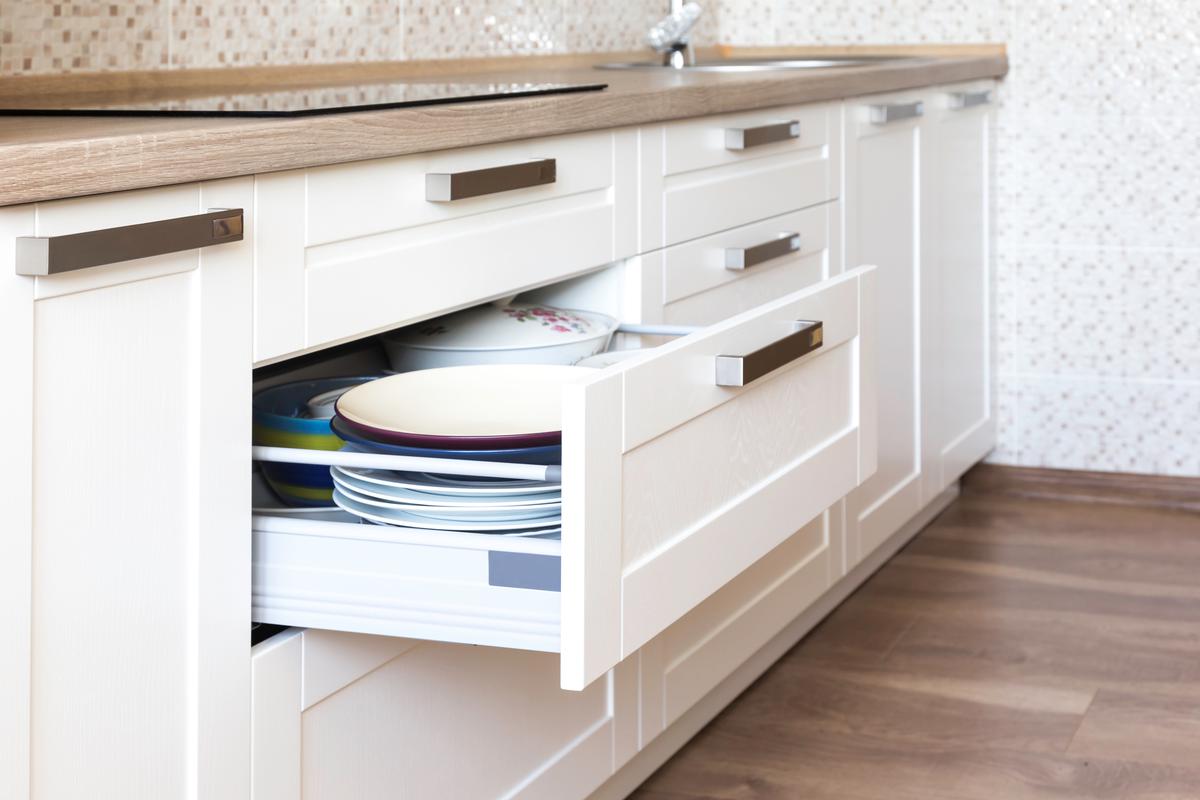 Dividers, appliances, and deep drawers maximize storage and functionality.