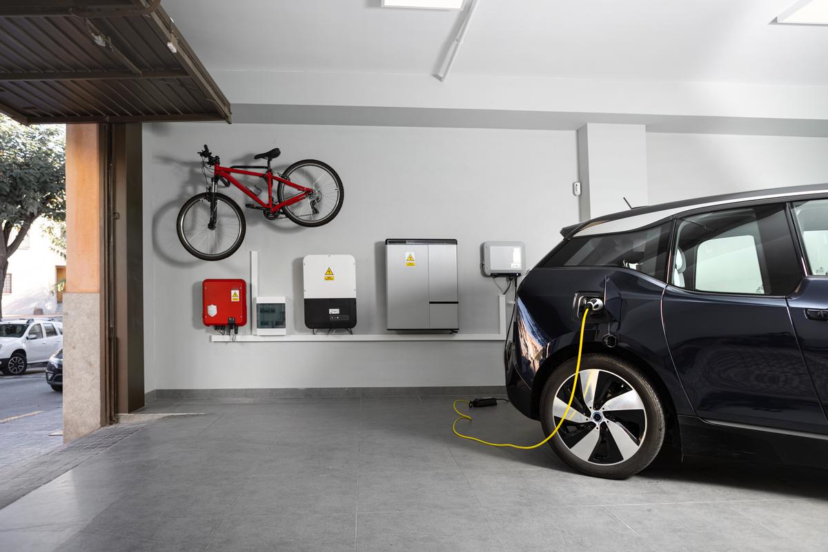Professional electrician installing an EVSE charging station, ensures safe and efficient charging for electric vehicles.