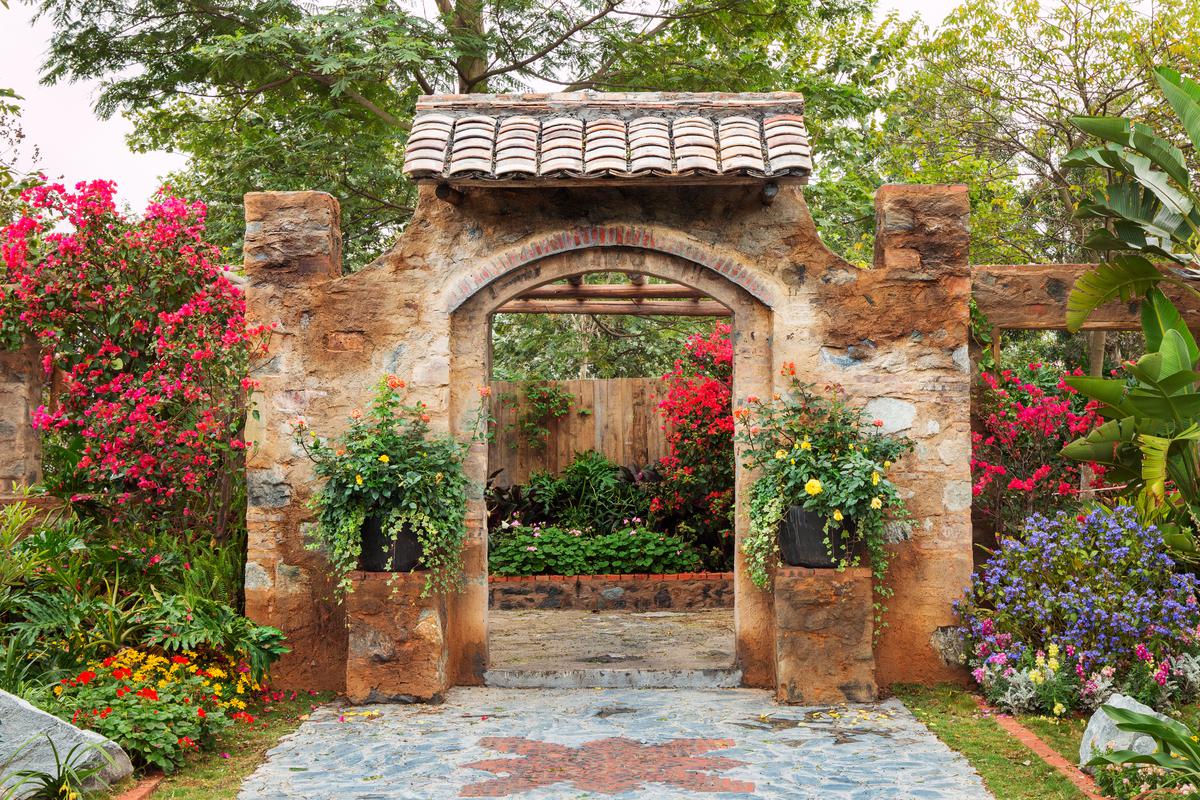A charming mosaic pathway brings vibrant colors and whimsy to the serene backyard oasis.