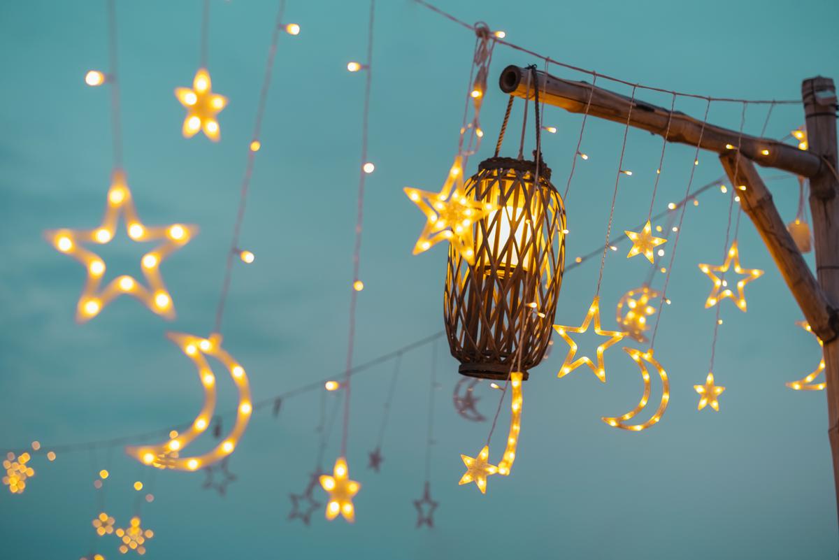 Illuminate your backyard paradise with enchanting outdoor lighting, casting a warm and inviting glow.