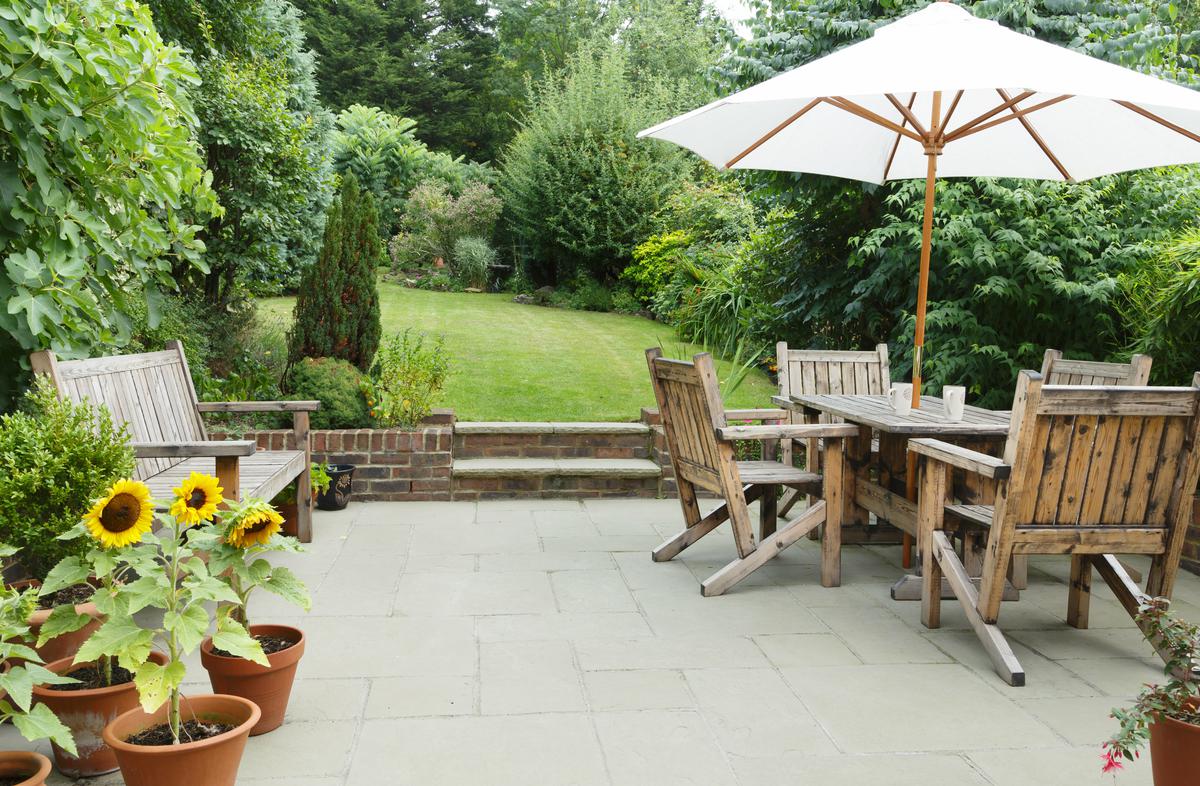 Transform your patio into an eco-friendly haven with repurposed materials, showcasing creativity and sustainability in your vibrant garden.
