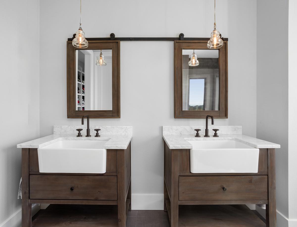 The simple down-to-earth design of a farmhouse-style bathroom vanity is a hit with homeowners.