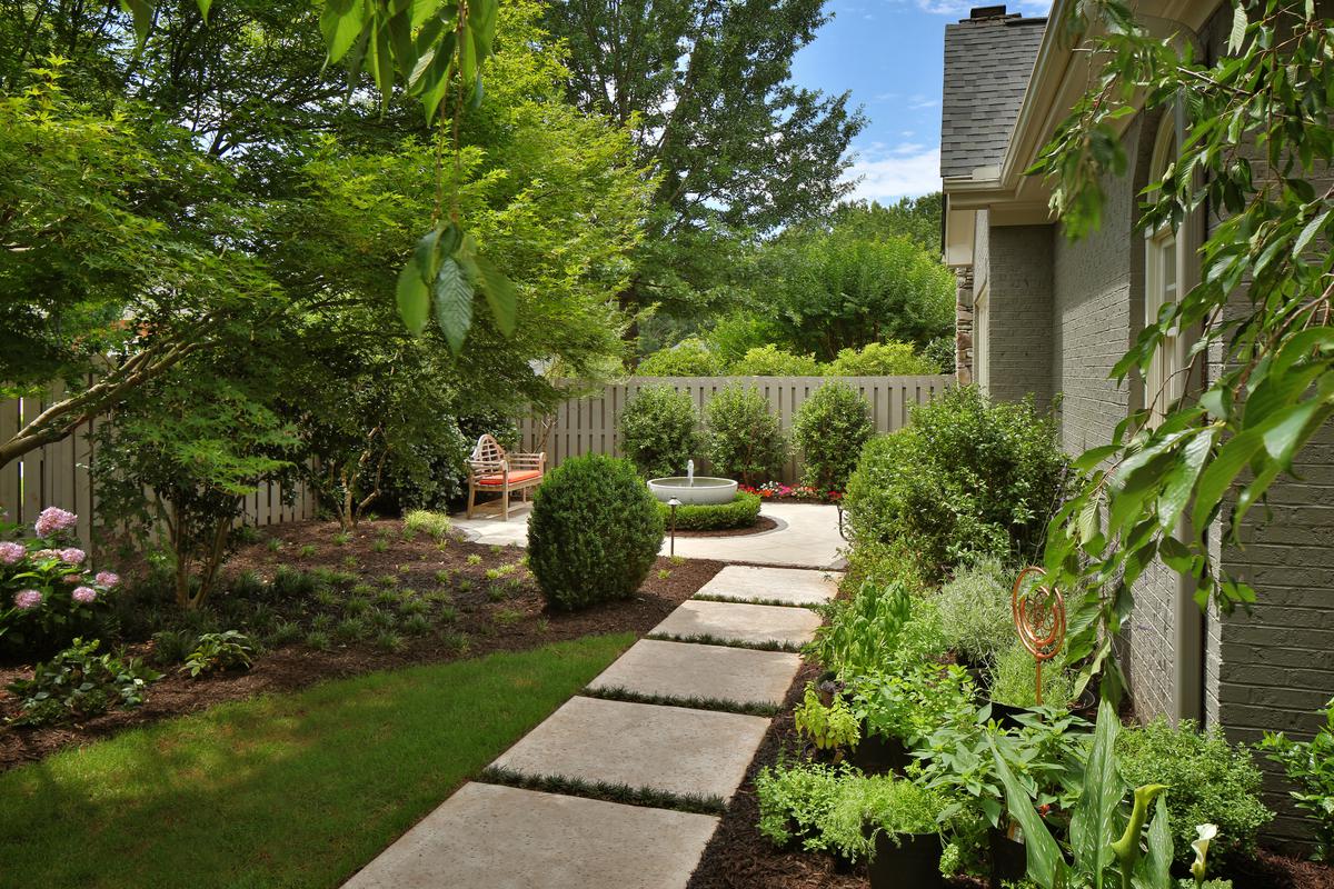 Enhancing the backyard with gravel and stone pathways create a harmonious balance between nature and design.