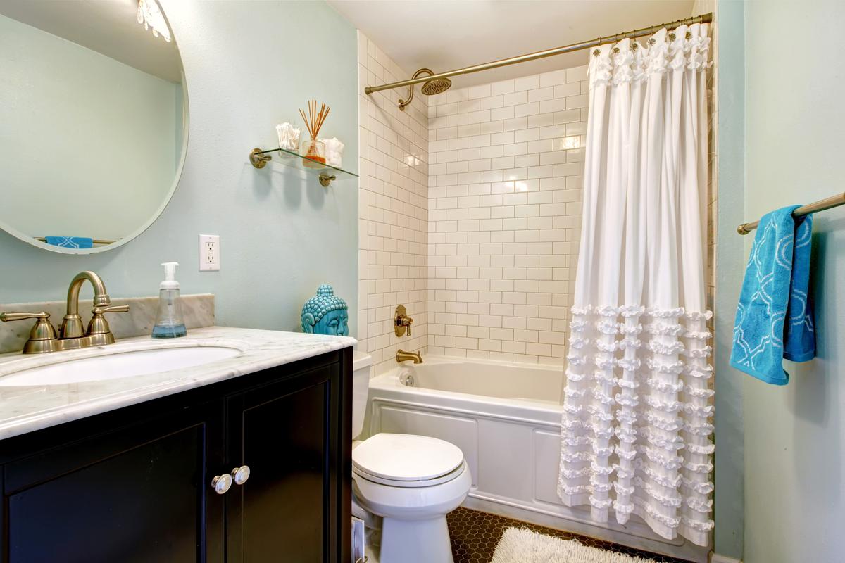 The Trick to Shower Curtains to Open Up the Space in Your Bathroom