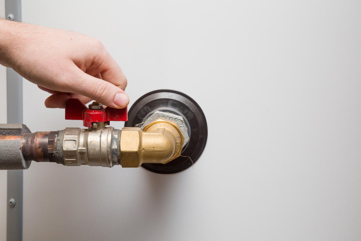 Turn off the gas supply to your water heater by turning the shutoff valve so that the red handle is at a right angle to your water heater tank.