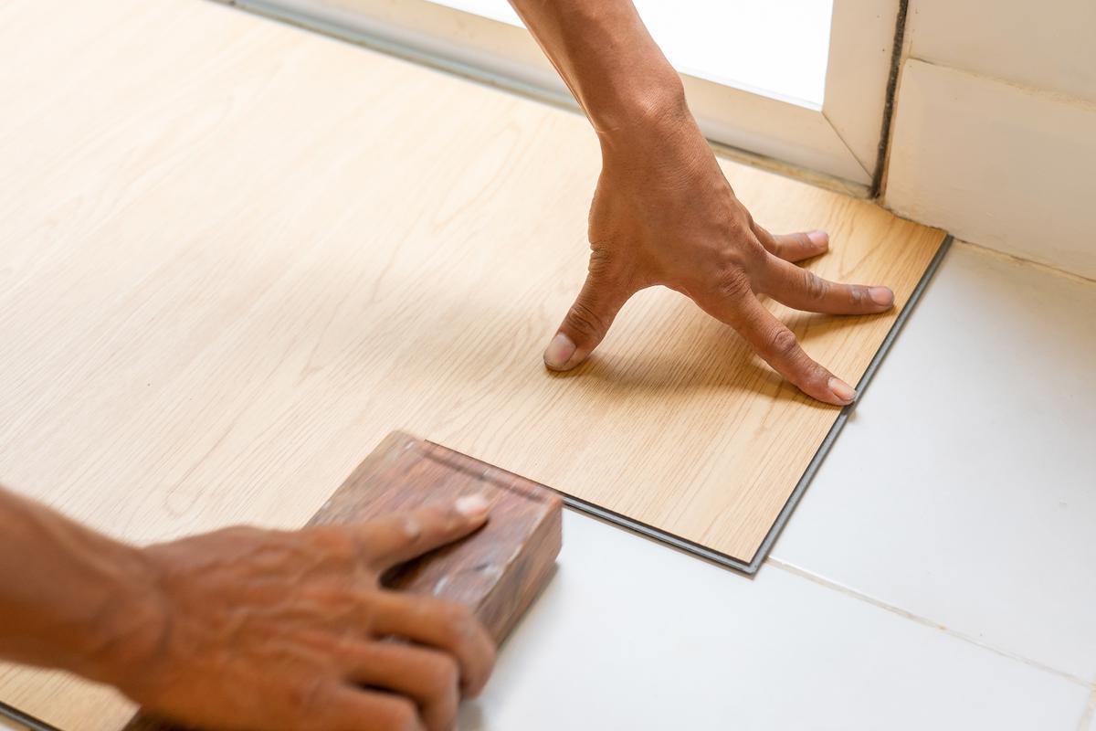 Using Weights to Help Lay Vinyl Floor Planks Seamlessly
