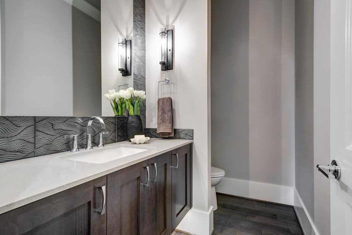 Mounting wall lamps on both sides of a vanity mirror makes for a practical lighting plan.