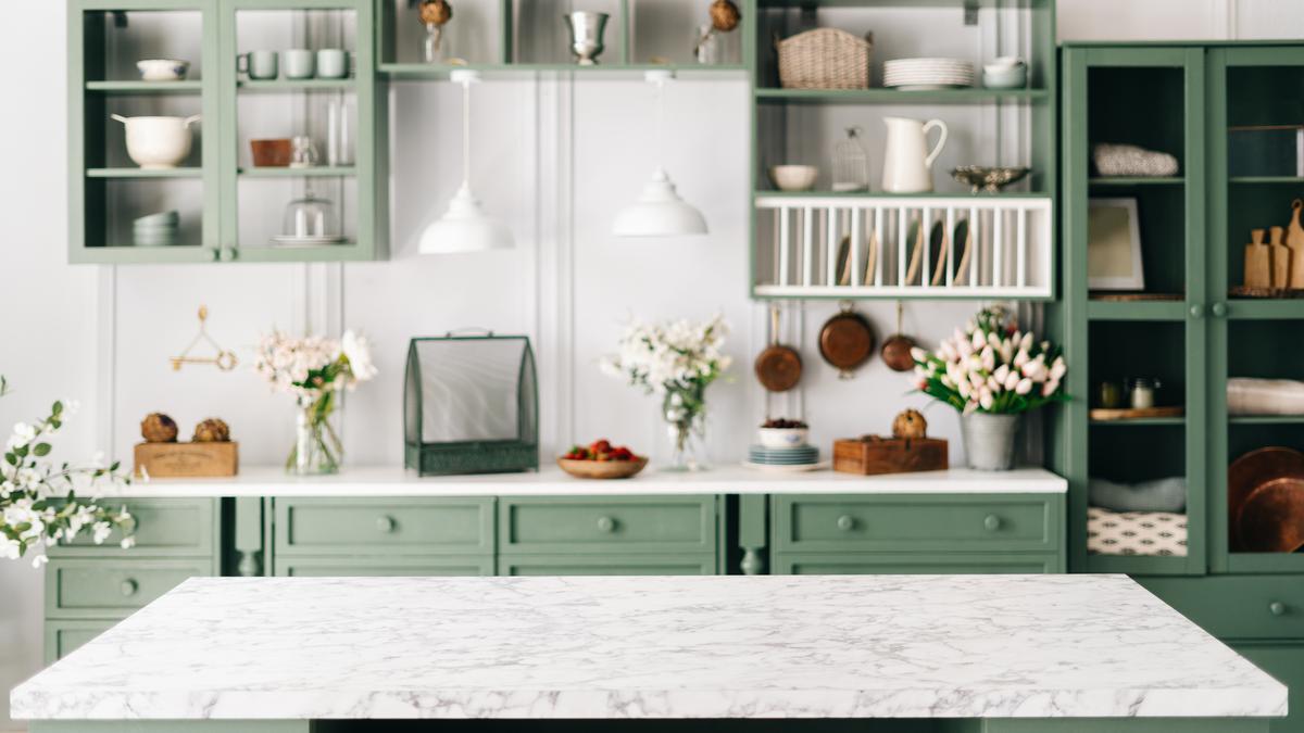 Warm organic colors such as teal are in for 2023 kitchen layouts and provide a beautiful contrast to a mostly white space.
