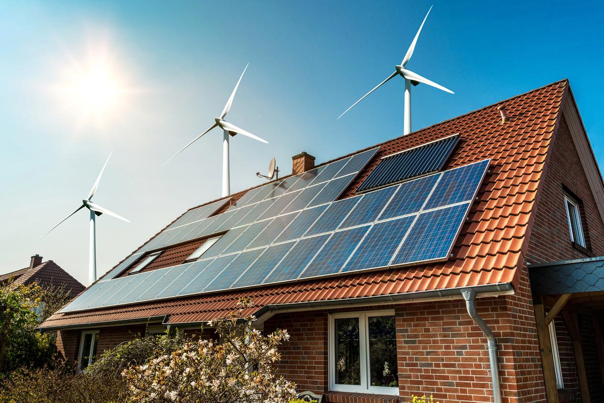 house with solar panels and wind turbines