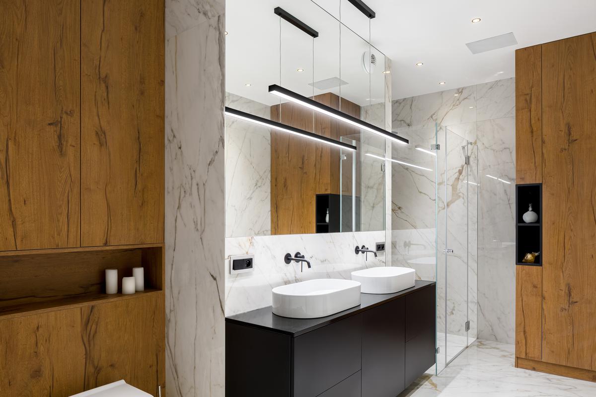 For a modern look, consider pairing a large mirror with linear pendants.