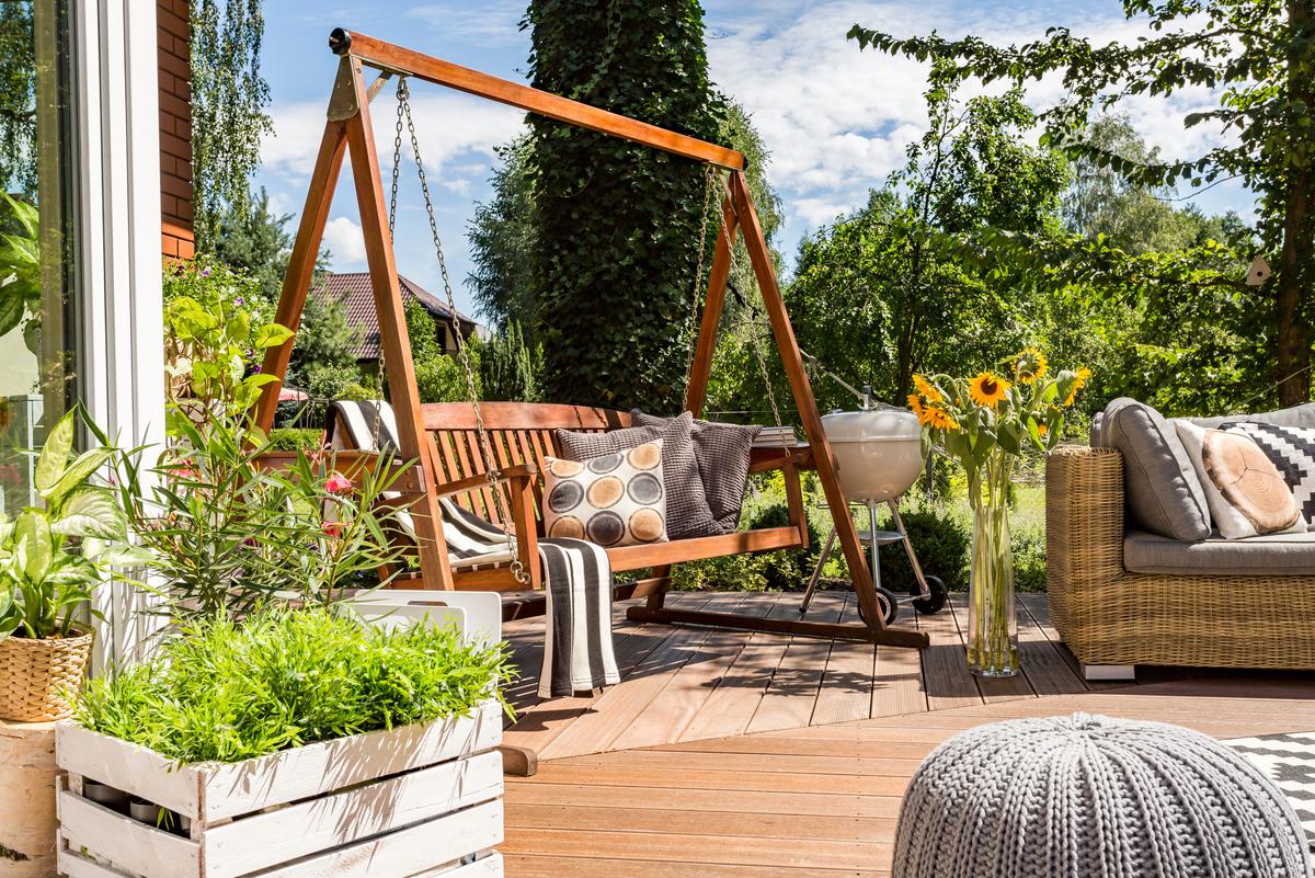 Transform your patio into a cozy retreat with functional and chic furniture options, from a DIY hammock to a wooden swing and storage bench.
