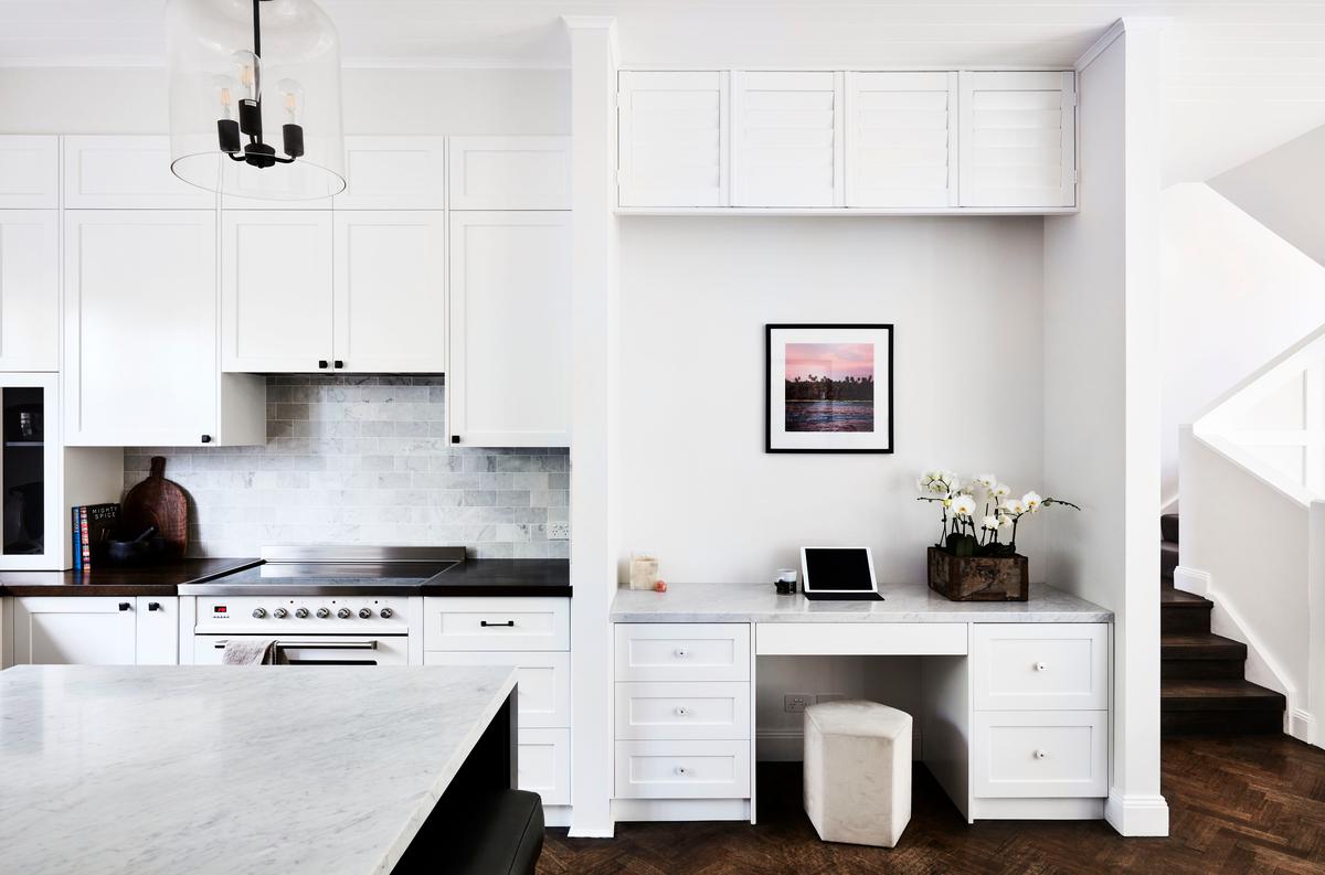 Among the kitchen design ideas of 2022 involves incorporating a home office into the space.