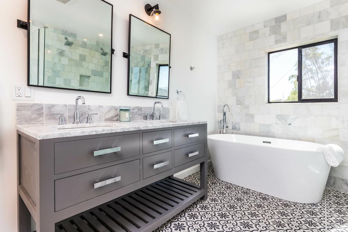 Placing a wall lamp as high as possible can make a low ceiling vanity area seem more spacious than it is.